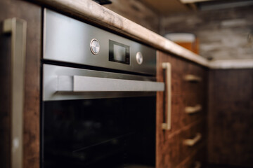 Fototapeta premium Modern kitchen interior in wenge colors with built-in appliances