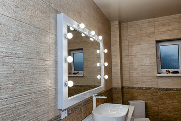 The interior of the bathroom with a big illuminated mirror