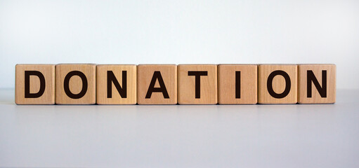 Concept word 'donation' on wooden cubes on a beautiful white background. Business concept.