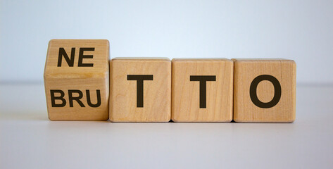 Wooden cubes and changes the word 'netto' to 'brutto'. Beautiful white background. Business concept, copy space.