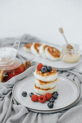 Tasty curd cheesecakes with berries on a plate. High quality photo
