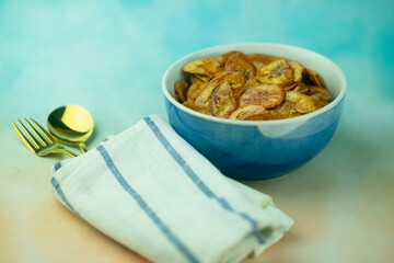 Homemade dehydrated banana chips cuisine fried in hot oil baked.
