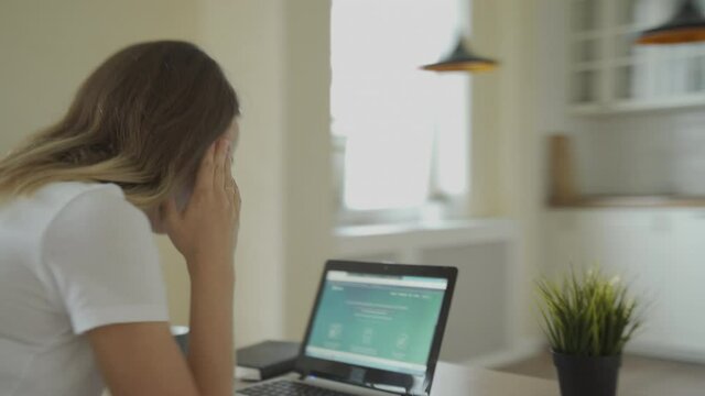 Woman Sitting At His Desk In Home Office Studio Working On A Laptop Writes Down Notes. Energetic Fast Paced Time-lapse Fast Forward Movement. 360 Degree Tracking Arc Shot