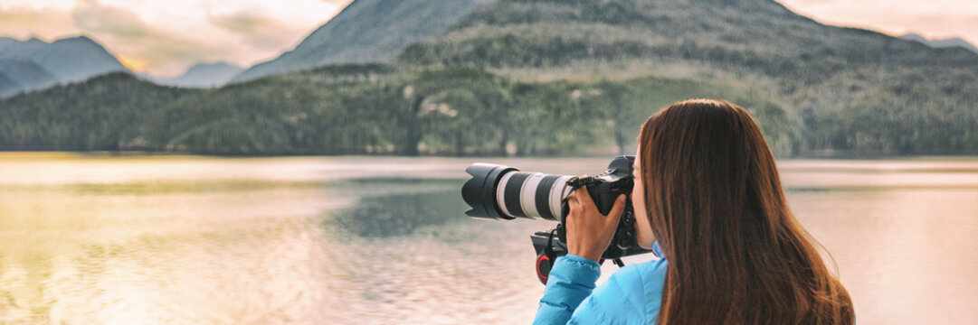 Travel photography professional photographer woman tourist shooting with professional telephoto lens camera on tripod shooting wildlife on Alaska cruise panoramic banner.