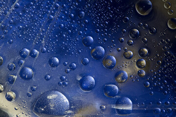 Blue and gold spheres of different diameters are located on the multi-colored background. Cosmic abstraction.