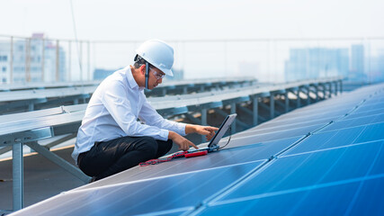 Electrical engineers are using tablets to monitor the operation of the solar rooftop. Renewable...