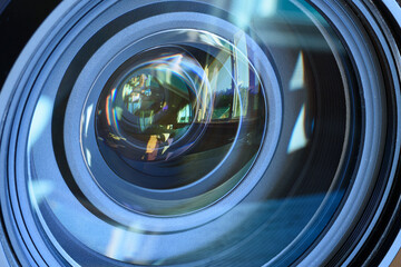 The view from the window reflected in the glass of the lens
