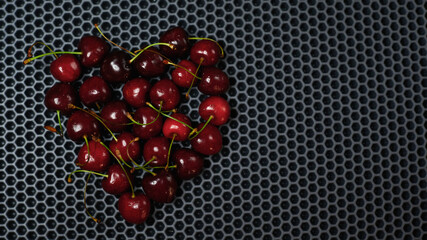cherry on a dark background on the top left close up, place to paste