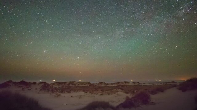 Timelapse of freight ships at night under a rotating Milky Way.