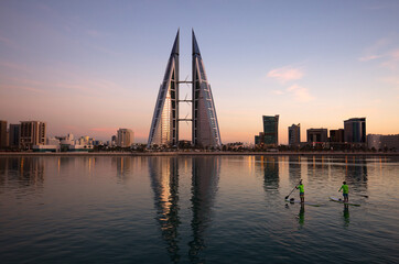 Enthusiasts kyaking near the iconic building of Bahrain