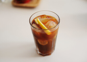Fototapeta na wymiar Espresso tonic with lemon slice in bid glass with ice