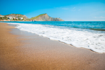 Sandy beach with mountains and blue sky