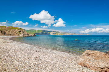 Beach with mountains on the background.