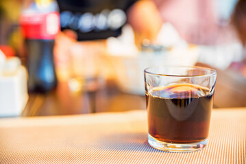 Cold cola in a glass on a table