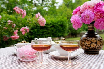 cup of tea, martini glasses and roses flowers