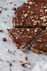 Delicious hazelnut chocolate tart, topped with nuts