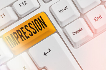 Writing note showing Impression. Business concept for an idea and feeling or opinion about something or someone Colored keyboard key with accessories arranged on empty copy space
