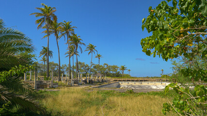 Empty swimming pool and adjacent tourist resort diminish in the tropical weather