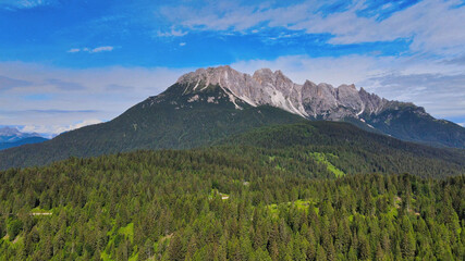 Aerial view of Auronzo Lake and Town in summertime, italian dolomites