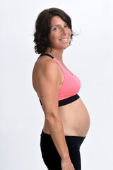 Fototapeta premium portrait of a pregnant woman with sportswear isolated on white background,