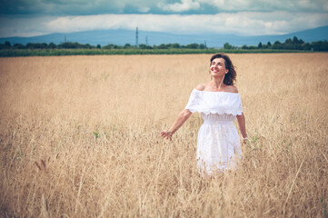 Happy woman on wheat field