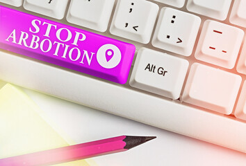 Writing note showing Stop Arbotion. Business concept for advocating against the practice of...