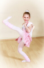 happy small ballerina at dancing school
