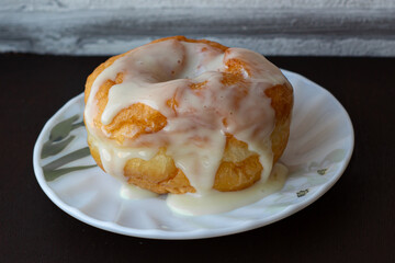 Big juicy donut poured on with condensed milk