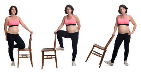 group of same prengnant woman playing with a chair on white background