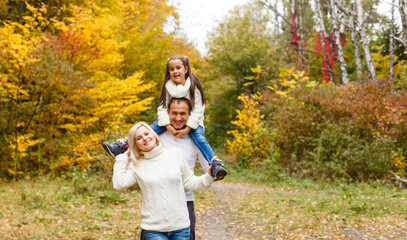Fototapeta premium family, childhood, season and people concept - happy family in autumn park