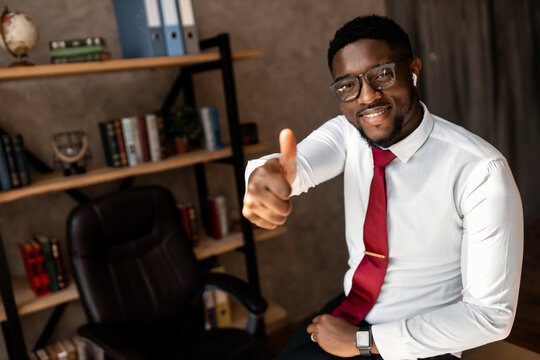 Portrait Of Handsome African Business Man With Red Tie And Black Glasses In The Office