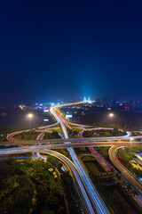 At night freeway cars run over overpasses