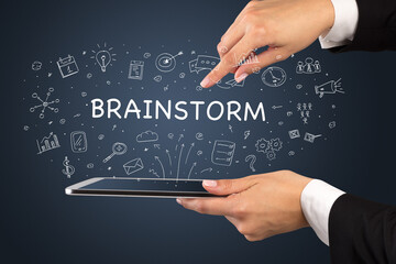 Close-up of a touchscreen with BRAINSTORM inscription, social media concept