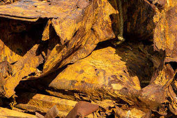 A rusty metal iron with a decorative pattern