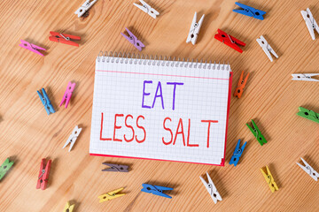 Conceptual hand writing showing Eat Less Salt. Concept meaning reducing the sodium intake on the...
