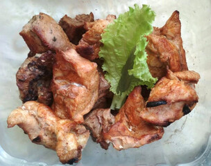 Pieces of pork kebab with lettuce. Juicy, delicious, toasted meat. Top view.