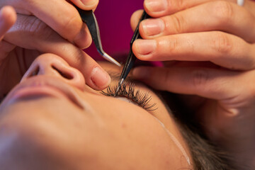 Eyelash Extension Procedure. Woman Eye with Long Eyelashes. Lashes. With Mask Medicinal Covid.