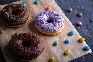 Donuts on a wooden board on a blue concrete background