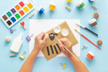 3 Diy Eid al adha lamb sheep baby craft on blue background. Gift idea, decor Eid al adha. Step by step. Top view. Process kid children craft.