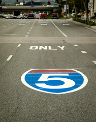 Sign for the interstate 5 freeway painted on the pavement shot from the driver&rsquo;s perspective