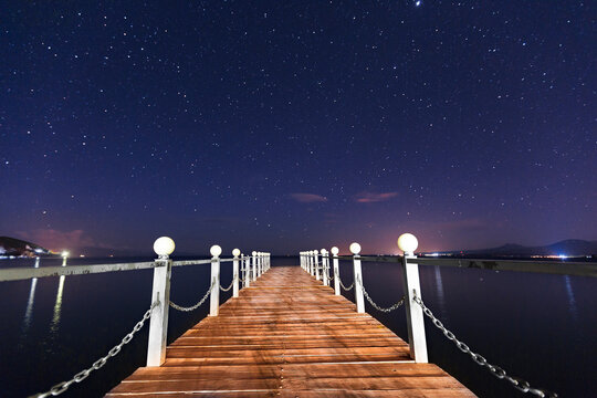 Wooden pier at the Lake Sevan with stars in the sky, Armenia.
