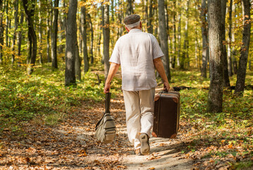 Retirement travel and hobbies. Always have bag ready to go. Elderly carry travel bag. Old man...