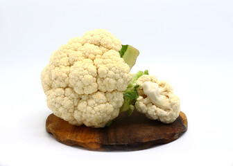 Raw cauliflower on a cutting board on a light background. Natural product. Natural hue. Close-up.