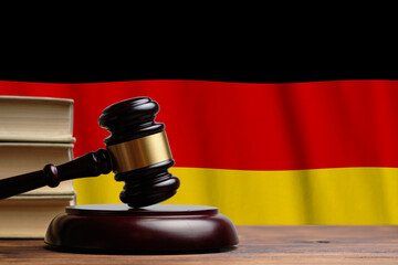 Justice and court concept in Federal Republic of Germany. Judge hammer on a flag background.