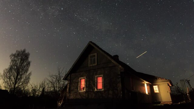 Small wooden summer house at night sky timelapse