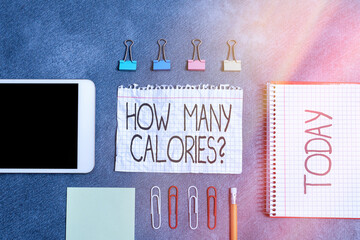 Conceptual hand writing showing How Many Calories Question. Concept meaning asking how much energy our body could get from it Paper accessories with smartphone arranged on different background