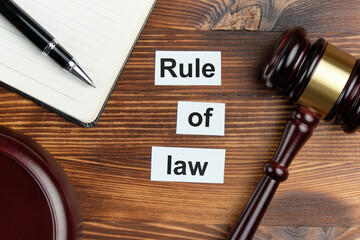 Rule of law - an inscription on wooden cubes with a number of judge hammer.