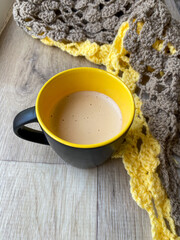 cup of coffee and knitted plaid