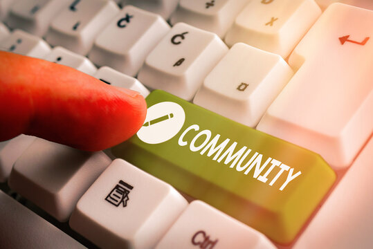 Word writing text Community. Business photo showcasing group of showing with a common characteristics living together White pc keyboard with empty note paper above white key copy space