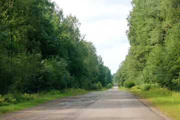old asphalt country road in the forest, Russia